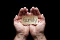 Family protected in cupped hands