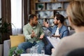 A family psychologist conducts a session in a beautiful office. LGBT couple at a psychotherapist's appointment