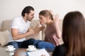 Family psychologist counseling. Couple quarrelling, shouting and