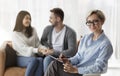 Family Psychologist Smiling While Couple Reconciling Sitting On Sofa Indoor Royalty Free Stock Photo