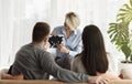 Family Psychologist Working With Couple Showing Inkblot Picture In Office