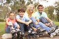 Family Putting On In Line Skates In Park Royalty Free Stock Photo