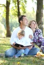 Family read the Bible in nature