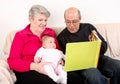 Family reading book to baby Royalty Free Stock Photo