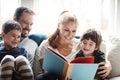Family, reading book together with parents and children, happiness at home with story time and learning. Love Royalty Free Stock Photo