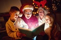 Family reading Christmas magic book Royalty Free Stock Photo