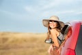 Family ready for the travel on summer vacation. Cute happy smiling little girl child is sitting in the red car with luggage and Royalty Free Stock Photo