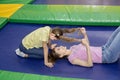 Family recreation ideas. Happy mother having great time with her daughter at indoor trampoline park