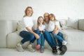 Family and relationship concept. Beautiful and happy smiling young family in white T-shirts are hugging and have a fun time Royalty Free Stock Photo