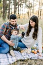 Family, relationships and people concept. Happy father, mother and little child boy having fun together in autumn forest Royalty Free Stock Photo