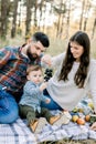 Family, relationships and people concept. Happy father, mother and little child boy having fun together in autumn forest Royalty Free Stock Photo