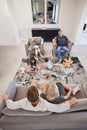 Family, relax and children playing with toys on the floor in the living room while bonding. Calm grandparents and Royalty Free Stock Photo