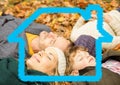 Family relaxing on dry leaves with house model Royalty Free Stock Photo