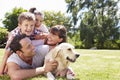 Family Relaxing In Garden With Pet Dog Royalty Free Stock Photo