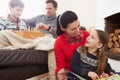 Family Relaxing Indoors Playing Chess And Reading Book Royalty Free Stock Photo