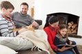 Family Relaxing Indoors Playing Chess And Reading Book Royalty Free Stock Photo