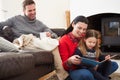 Family Relaxing Indoors And Reading Book Royalty Free Stock Photo