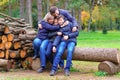 Family relaxing outdoor in autumn city park, happy people together, parents and children, they playing, talking and smiling, Royalty Free Stock Photo