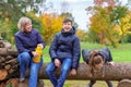 Family relaxing outdoor in autumn city park, happy people together, parents and children, they talking and smiling, beautiful Royalty Free Stock Photo