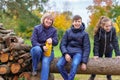 Family relaxing outdoor in autumn city park, happy people together, parents and children, they talking and smiling, beautiful Royalty Free Stock Photo