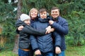 Family relaxing outdoor in autumn city park, happy people together, parents and children, they talking and smiling, beautiful Royalty Free Stock Photo