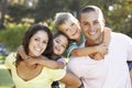 Family Relaxing In Summer Park