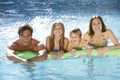 Family Relaxing In Swimming Pool Together Royalty Free Stock Photo