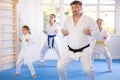 Family repeat position and perform sequence of punches and painful techniques kata