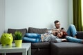 The family is resting on the couch all together. Concept of spending time together, happy family Royalty Free Stock Photo