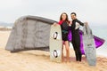 Family resting with kiteboard at the beach