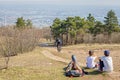 Family resting in nature, man down the hill on a bicycle. Beautiful view of Budapest city. Active lifestyle concept