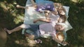 Family is resting in park - father, mother and daughter have breakfast - top view Royalty Free Stock Photo