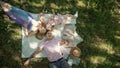 Family is resting in park - father, mother and daughter have breakfast - top view Royalty Free Stock Photo