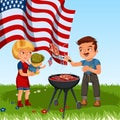 Family resting in park or garden, dad grilling meat on grill, mum holding baby on green grass with American flags, man Royalty Free Stock Photo