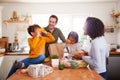 Family Returning Home From Shopping Trip Using Plastic Free Bags Unpacking Groceries In Kitchen Royalty Free Stock Photo