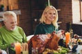 Family reunion old generation celebrate thanksgiving eat stuffed turkey dinner table communicating house living room Royalty Free Stock Photo
