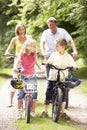 Family riding bikes in countryside