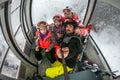 Family riding cabin cable car on winter vacation skiing