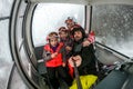 Family riding cabin cable car on winter vacation skiing