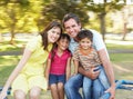 Family Riding On Roundabout In Park