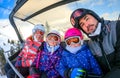 Family riding ski lift cable car on winter vacation skiing Royalty Free Stock Photo