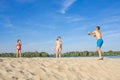 Family on the river bank playing beach volleyball on a sunny, summer day Royalty Free Stock Photo