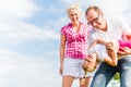 Family romping on field Royalty Free Stock Photo