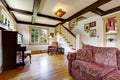 Family room with antique piano and comfortable red sofa