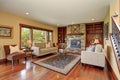 Family room in antique style with natural stone design fireplace and old sofa set. Royalty Free Stock Photo