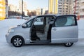 Family roomy auto side view of the toyota porte brand in gray with an opened automatic door outside in the winter, a minivan