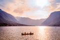 Family rowing in canoe boat on beautiful lake Bohinj, Slovenia.