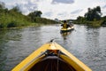 Family rowing in a yellow kayak in summer of Oskol river.