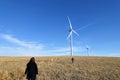 A family running across a field with a Wind turbine in the background across the vast farm land of Alberta, Canada. Royalty Free Stock Photo