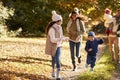 Family Running Along Path Through Autumn Countryside Royalty Free Stock Photo